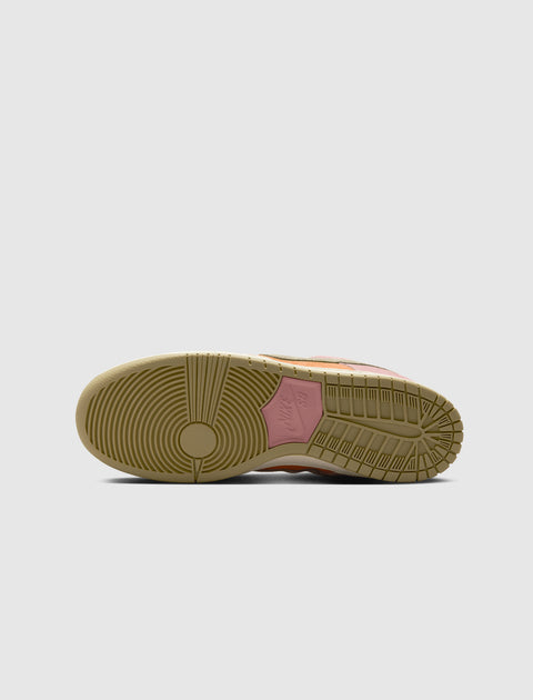Close-up of gum sole with pink Nike SB branding on a sneaker, isolated on grey background