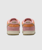 Back view of pink and orange Nike low-top sneakers with suede accents