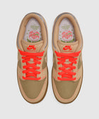 Top view of tan and olive green Nike SB Dunk Low sneakers with bright orange laces