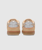 Beige and silver low top sneakers with textured uppers, viewed from the back