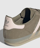 Close-up of suede Adidas Gazelle sneaker in muted pink and beige with translucent sole
