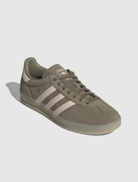 Olive green suede sneaker with pink stripes and gum sole, side view on white background