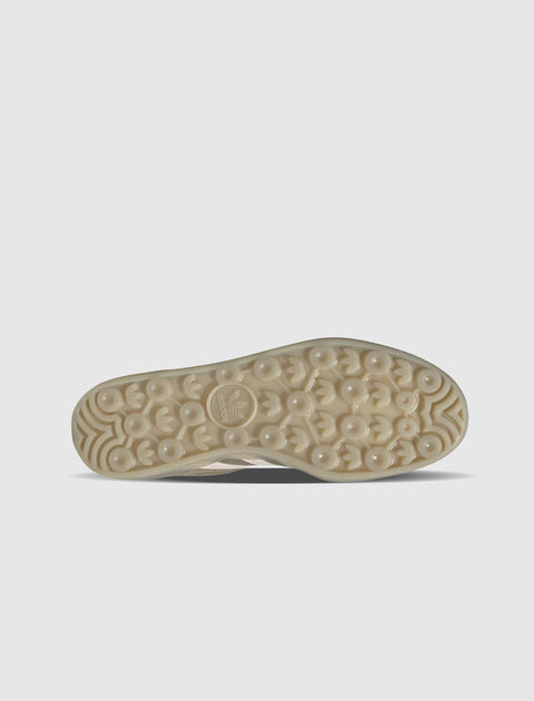 Cream patterned sneaker sole with circular grip and adidas logo on a light background