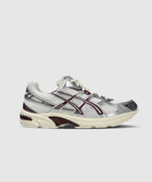 Cream and purple mesh and leather sneaker with silver accents on a white background