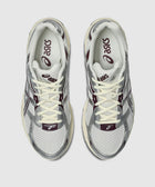 Top view of cream and purple athletic sneakers with mesh and synthetic overlays