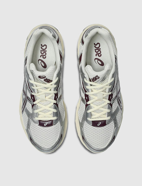 Top view of cream and purple athletic sneakers with mesh and synthetic overlays