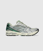 Men's running sneaker in silver, green, and beige with mesh and synthetic overlays