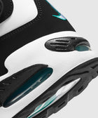 Close-up of black, white, and teal men's sneaker with visible air sole and stitched detail