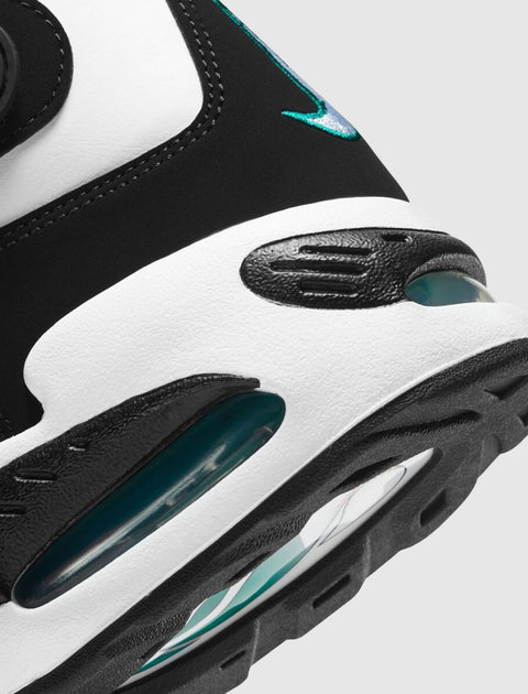Close-up of black, white, and teal men's sneaker with visible air sole and stitched detail