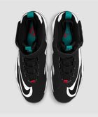 Black and white athletic sneakers with teal tongue tab, red logo, and bold swoosh design