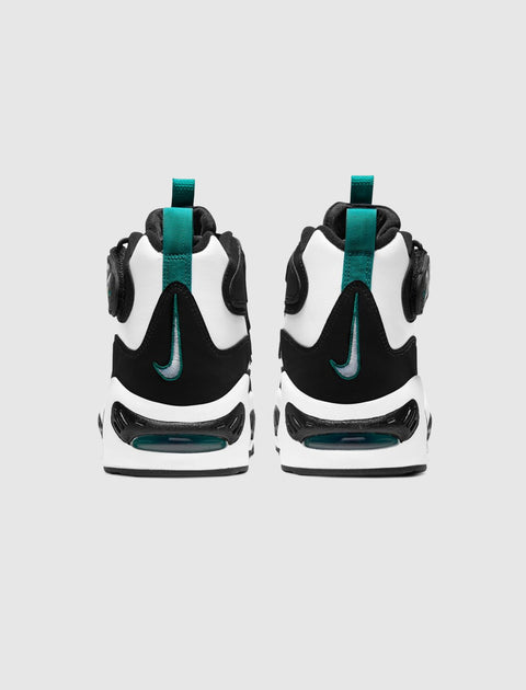 Back view of black, white, and teal athletic sneakers with visible air sole and pull tabs
