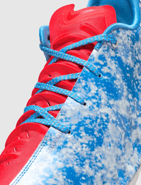 Close-up of blue and white speckled basketball sneaker with red tongue and blue laces