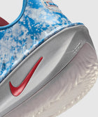Close-up of blue and white Nike sneaker with red swoosh and Zoom Air sole
