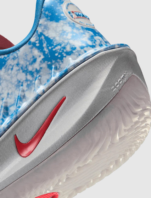 Close-up of blue and white Nike sneaker with red swoosh and Zoom Air sole