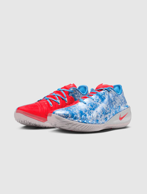 Pair of Nike sneakers with blue and red mismatched design on a white background