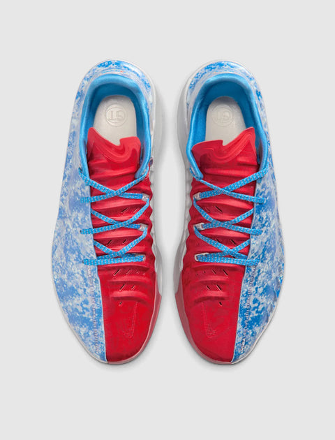Red and blue athletic sneakers with speckled pattern and blue laces, top view