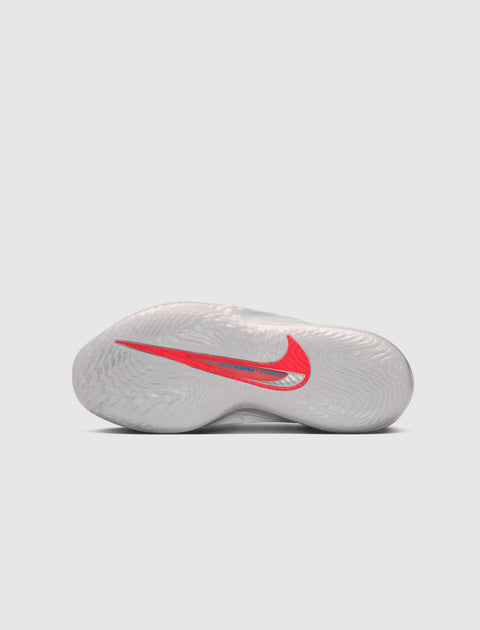 White basketball sneaker outsole with red Nike Swoosh and circular traction pattern