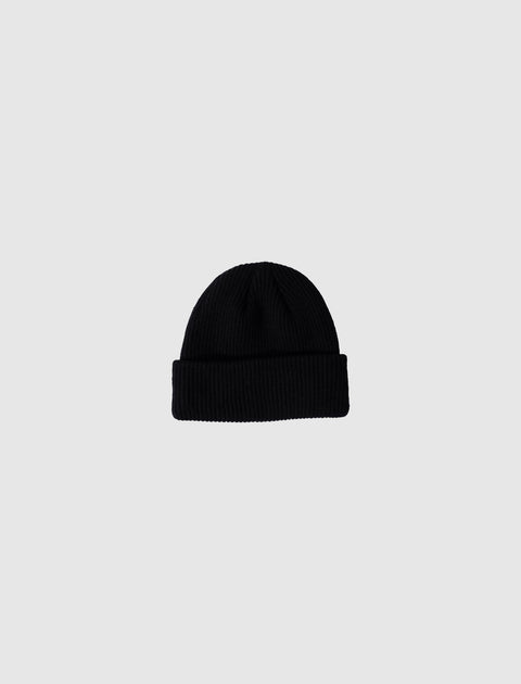 Black ribbed knit beanie on a plain light grey background