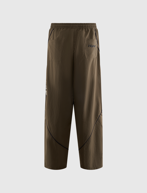 Brown men's streetwear pants with back pockets, elastic waistband, and black contrast seams