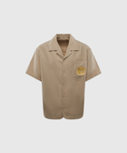 Beige short sleeve button-up shirt with yellow sun graphic on chest pocket, men's streetwear