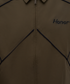 Close-up of brown zip-up jacket with navy piping and 'Honor' embroidered on chest