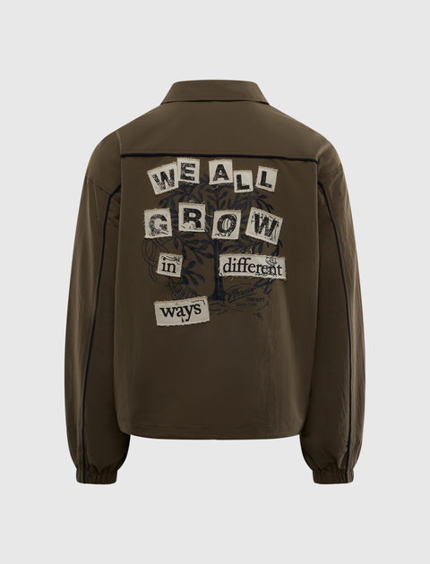 Brown men's streetwear jacket with 'We All Grow in Different Ways' graphic on back.