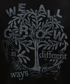 Black streetwear t-shirt graphic with tree and 'We all grow in different ways' text design
