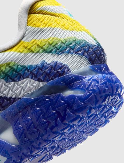 Close-up of a multicolor athletic sneaker heel with textured blue rubber outsole