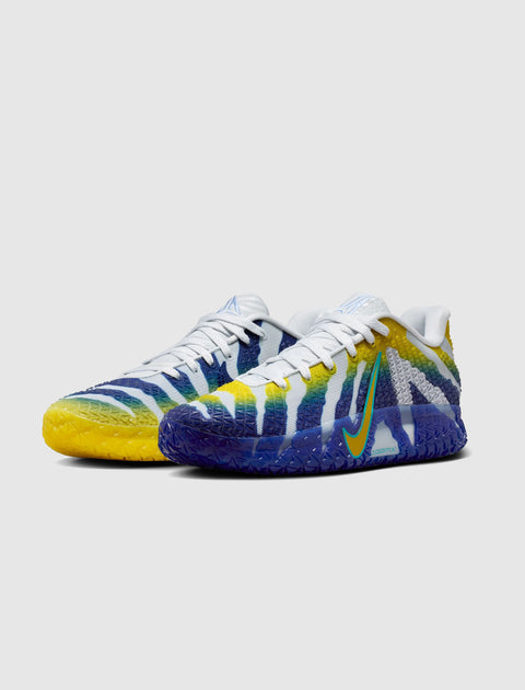 White, blue, and yellow men's sneakers with gradient sole and bold stripe pattern