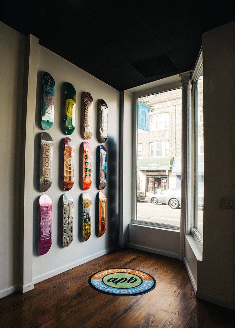 Streetwear shop corner with wall-mounted skateboard decks and large front window