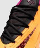 Close-up of vibrant orange and black athletic sneaker with mesh upper and textured swoosh logo