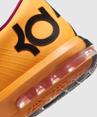 Close up of orange sneaker heel with black KD logo, visible air cushion and textured sole
