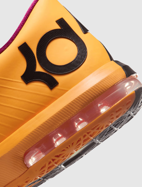 Close up of orange sneaker heel with black KD logo, visible air cushion and textured sole
