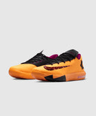 Orange and black low-top basketball sneakers with maroon accents and textured swoosh logo