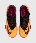 Top view of orange and black men's sneakers with purple interior and textured Nike swoosh.