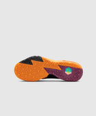 Colorful geometric sole of a men's sneaker in orange, black, and purple on white background
