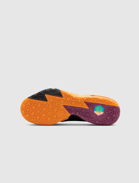 Colorful geometric sole of a men's sneaker in orange, black, and purple on white background