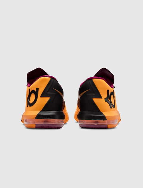 Back view of orange and black athletic sneakers with bold zigzag pattern and visible logo