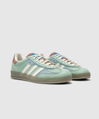 Light green and blue suede low-top sneakers with white stripes and gum sole