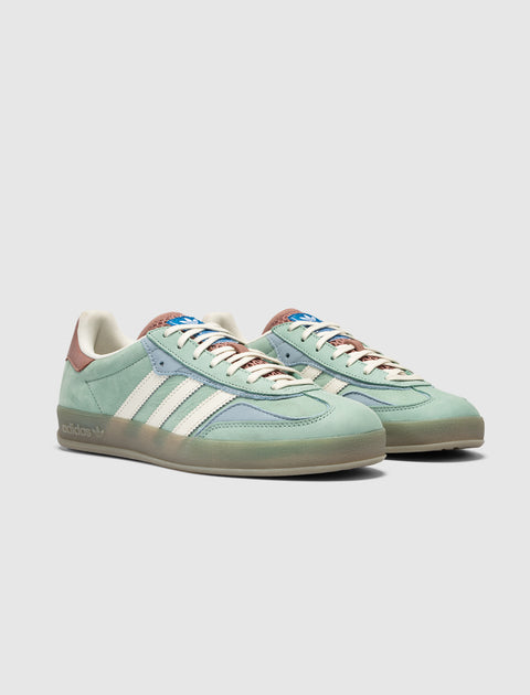 Light green and blue suede low-top sneakers with white stripes and gum sole