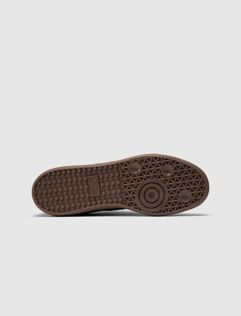 Brown gum sole of a men's sneaker with textured grip and circular tread pattern