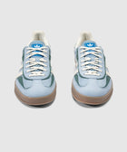 Light blue and green suede sneakers with gum soles and white laces, front view