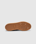 Brown rubber sneaker outsole with geometric tread pattern, viewed from below