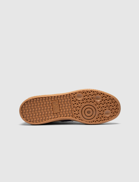 Brown rubber sneaker outsole with geometric tread pattern, viewed from below