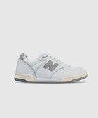 White and grey leather low-top sneaker with mesh panels and lace-up closure on white background