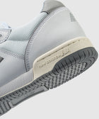Close-up of light grey and white sneaker with New Balance branding and textured sole