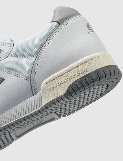 Close-up of light grey and white sneaker with New Balance branding and textured sole