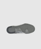 Gray rubber outsole of a men's sneaker with detailed tread pattern on white background