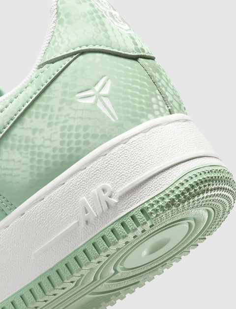 Mint green Nike Air Force 1 sneaker with textured upper and white sole, closeup view