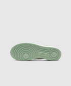 Light green Nike sneaker sole with circular tread pattern, streetwear footwear